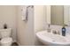Cozy half bathroom featuring white fixtures and decorative touches at 1035 Evening Shade Ave, Rolesville, NC 27571