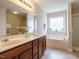 Bathroom with a double sink vanity, garden tub, and glass enclosed shower at 1035 Evening Shade Ave, Rolesville, NC 27571