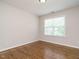 Clean bedroom with hardwood floors and natural light from a large window at 1035 Evening Shade Ave, Rolesville, NC 27571