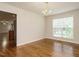 Dining room with hardwood floors, view into kitchen, and natural light from a large window at 1035 Evening Shade Ave, Rolesville, NC 27571