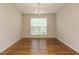 Bright dining room with a chandelier, hardwood floors, and natural light from a large window at 1035 Evening Shade Ave, Rolesville, NC 27571