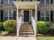 Inviting front entrance with brick steps, white railings, and lush landscaping at 1035 Evening Shade Ave, Rolesville, NC 27571
