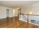 Spacious hallway featuring hardwood floors and a decorative pendant light at 1035 Evening Shade Ave, Rolesville, NC 27571
