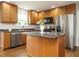 Kitchen with stainless steel appliances, granite countertops, and wooden cabinetry at 1035 Evening Shade Ave, Rolesville, NC 27571