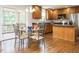 Kitchen with stainless steel appliances, granite countertops, dining area, and access to porch at 1035 Evening Shade Ave, Rolesville, NC 27571