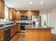 Kitchen features stainless steel appliances, granite countertops, and wooden cabinetry at 1035 Evening Shade Ave, Rolesville, NC 27571