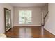 Bright living room with hardwood floors and ample natural light from a large window at 1035 Evening Shade Ave, Rolesville, NC 27571