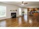 Open-concept living room with fireplace, hardwood floors, and natural light at 1035 Evening Shade Ave, Rolesville, NC 27571
