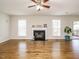 Living room with fireplace, hardwood floors, and access to porch at 1035 Evening Shade Ave, Rolesville, NC 27571