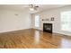 Bright living room features hardwood floors, fireplace, and natural light from large windows at 1035 Evening Shade Ave, Rolesville, NC 27571
