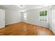 Well-lit bedroom featuring hardwood floors and two bright windows at 110 Virens Dr, Cary, NC 27511