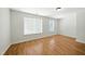 Bright bedroom with hardwood floors and natural light from two windows at 110 Virens Dr, Cary, NC 27511