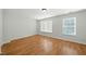 A well-lit bedroom features hardwood floors and two large windows at 110 Virens Dr, Cary, NC 27511