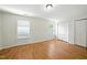 Bright bedroom features hardwood floors, two windows, and a double-door closet at 110 Virens Dr, Cary, NC 27511