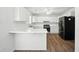 Efficient kitchen with white cabinetry, laminate countertops and stainless steel appliances in a convenient layout at 110 Virens Dr, Cary, NC 27511