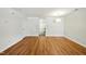 Spacious living room featuring hardwood floors, and a contemporary light fixture, ideal for relaxation and gatherings at 110 Virens Dr, Cary, NC 27511