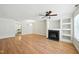 Bright living room with hardwood floors, ceiling fan, fireplace, and built-in shelving perfect for entertaining at 110 Virens Dr, Cary, NC 27511