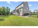 Exterior shot of the house showing a spacious, grassy backyard and patio at 1123 Ambrose Dr, Rolesville, NC 27571