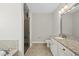 Bathroom with granite countertop, white cabinets, shower, and separate toilet at 1123 Ambrose Dr, Rolesville, NC 27571
