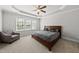 Spacious bedroom featuring a tray ceiling, ceiling fan, and plenty of natural light at 1123 Ambrose Dr, Rolesville, NC 27571
