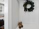 Entryway with neutral paint, trim detail, wreath, and a glimpse into the living space at 1123 Ambrose Dr, Rolesville, NC 27571
