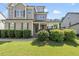 Inviting two-story home with covered porch, well-kept landscaping and dark trim at 1123 Ambrose Dr, Rolesville, NC 27571