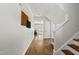 Bright foyer with hardwood floors, staircase, and view into the living area with natural light at 1123 Ambrose Dr, Rolesville, NC 27571