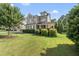 Charming two-story home with lush green lawn, manicured shrubs, and a welcoming front porch at 1123 Ambrose Dr, Rolesville, NC 27571