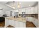 Bright kitchen with granite counters, stainless appliances and white cabinetry at 1123 Ambrose Dr, Rolesville, NC 27571
