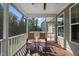 Relaxing screened porch with rocking chairs overlooking the backyard and mature trees at 1123 Ambrose Dr, Rolesville, NC 27571