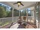Inviting screened porch featuring a ceiling fan and comfortable rocking chairs at 1123 Ambrose Dr, Rolesville, NC 27571