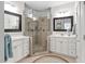 Bathroom with a corner glass shower, tiled floor, and double sink vanity at 11571 Auldbury Way, Raleigh, NC 27617