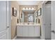 Bathroom with a large mirror, double sinks, vanity, and view to the hall with linen closet at 11571 Auldbury Way, Raleigh, NC 27617