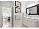 Bathroom featuring a single vanity and mirror, with a view into the Primary bedroom at 11571 Auldbury Way, Raleigh, NC 27617
