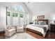 Spacious bedroom featuring a large window, hardwood floors, and a comfortable king bed at 11571 Auldbury Way, Raleigh, NC 27617