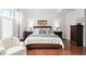Comfortable bedroom with a king-sized bed, hardwood floors, and large windows at 11571 Auldbury Way, Raleigh, NC 27617