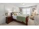 Cozy bedroom with a decorative bed, bedside table, and bright windows for natural light at 11571 Auldbury Way, Raleigh, NC 27617