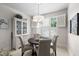 Charming breakfast nook with plenty of sunlight, plantation shutters, and a stylish light fixture at 11571 Auldbury Way, Raleigh, NC 27617