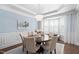 Elegant dining room featuring a chandelier, round table, and soft blue walls at 11571 Auldbury Way, Raleigh, NC 27617
