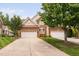 Inviting brick home with a well-manicured lawn, showcasing the attached two-car garage at 11571 Auldbury Way, Raleigh, NC 27617