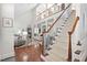 Grand two-story foyer with hardwood floors, a staircase, and views into the living room at 11571 Auldbury Way, Raleigh, NC 27617