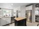 Modern kitchen with stainless steel appliances, granite countertops, and a black kitchen island at 11571 Auldbury Way, Raleigh, NC 27617