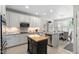 Bright kitchen featuring custom cabinets, granite counters, and a central island at 11571 Auldbury Way, Raleigh, NC 27617