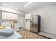 Laundry room with stainless steel refrigerator, washer, dryer, and storage cabinets at 11571 Auldbury Way, Raleigh, NC 27617