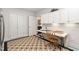 Laundry room with washer, dryer, ironing board, and storage cabinets at 11571 Auldbury Way, Raleigh, NC 27617