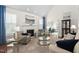 Bright living room with a fireplace, plush seating, and large windows at 11571 Auldbury Way, Raleigh, NC 27617