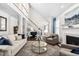 Spacious living room with high ceilings, hardwood floors, fireplace, and elegant staircase at 11571 Auldbury Way, Raleigh, NC 27617