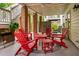 Outdoor patio with red Adirondack chairs, ceiling fan, and brick columns at 11571 Auldbury Way, Raleigh, NC 27617