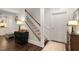 Inviting staircase with hardwood floors and a well-lit landing area, next to a small kitchen at 11571 Auldbury Way, Raleigh, NC 27617