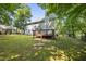Backyard with large grassy yard, and a beautiful two-story house with a wooden deck at 116 Hidden Cellars Dr, Holly Springs, NC 27540